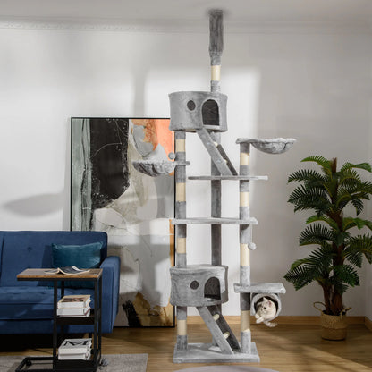 Arbre à chat sol plafond gris dans un salon moderne avec canapé bleu